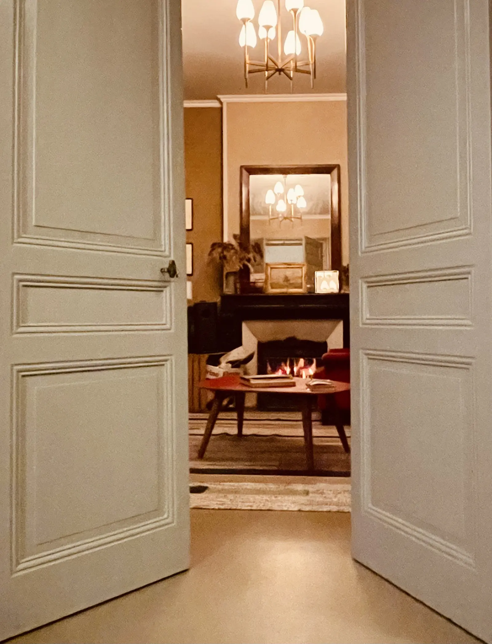 Le salon de la Villa Marguerite le soir, feu allumé dans la cheminée